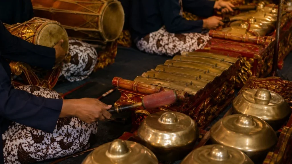 A traditional gamelan orchestra with bronze gongs and metallophones performing together